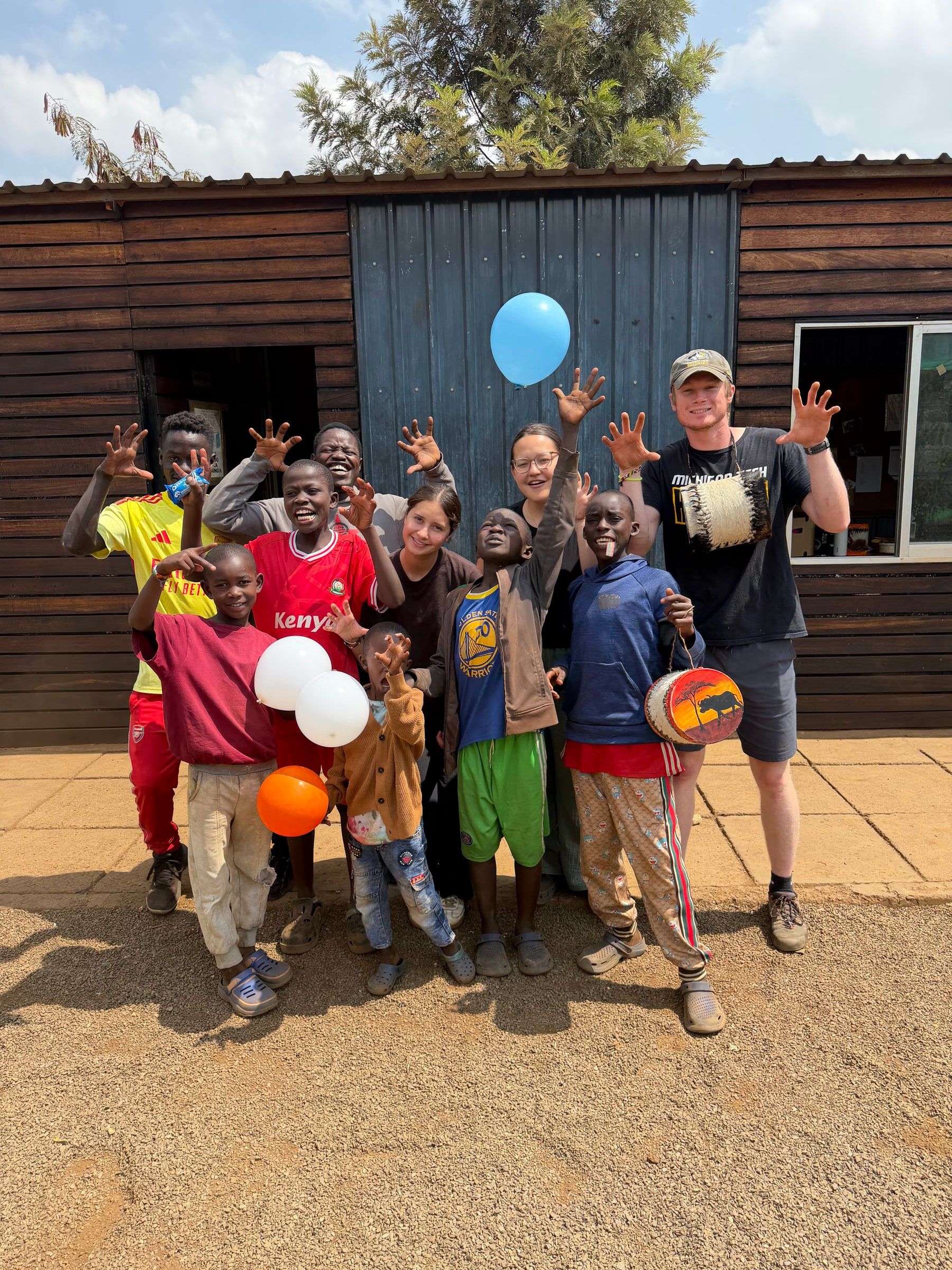 Boys and visiting team members gathered outside the Embrace Centre