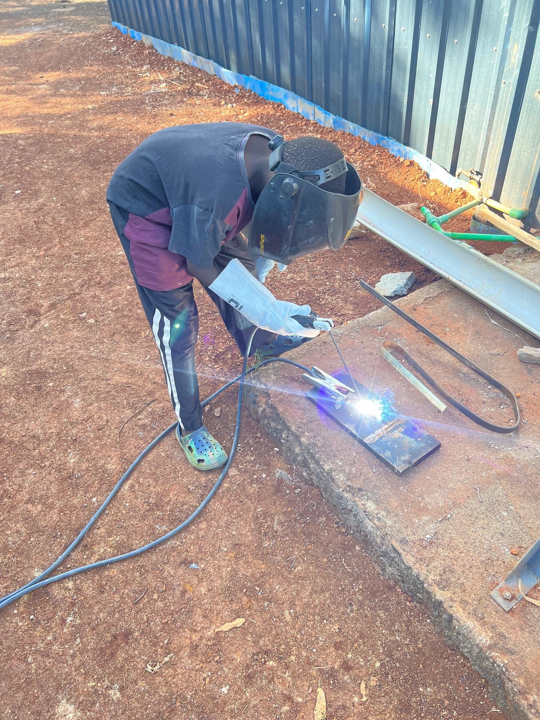 A boy learning welding during practical skills training at the Centre