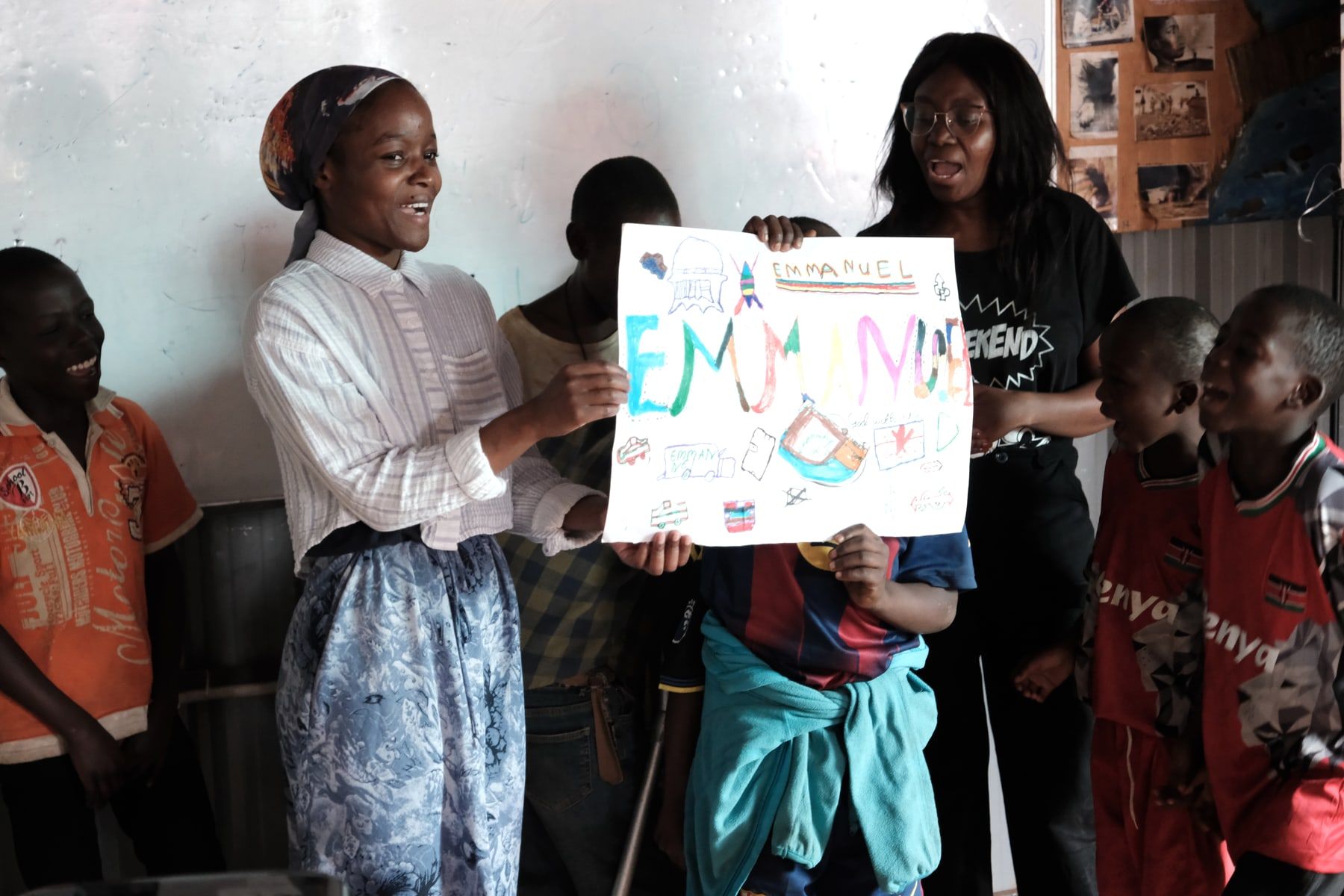 Children presenting a creative activity poster during Embrace Camp
