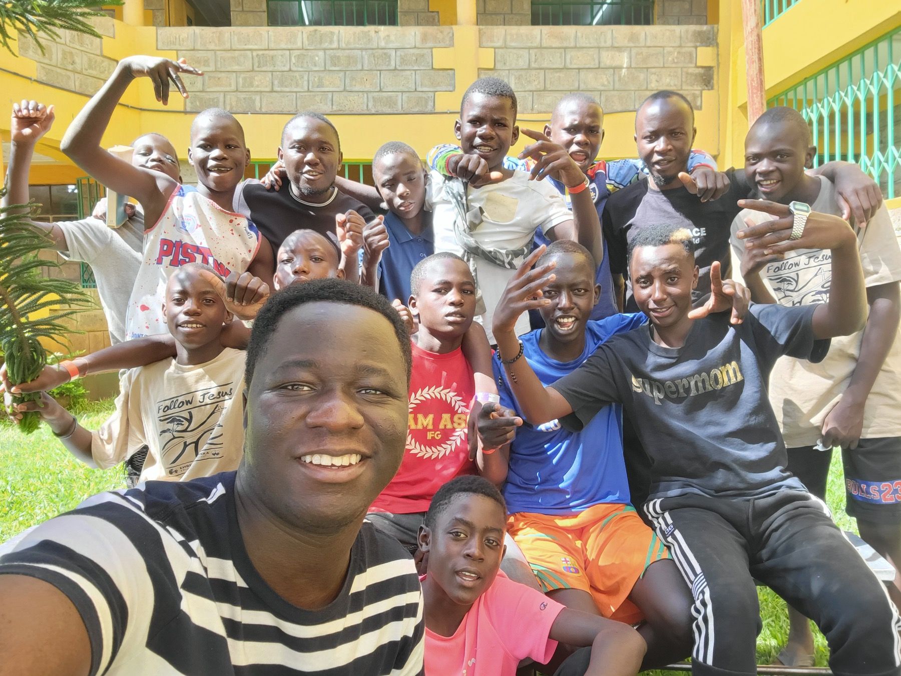 Boys and visiting team members gathered for a group photo during Embrace Camp