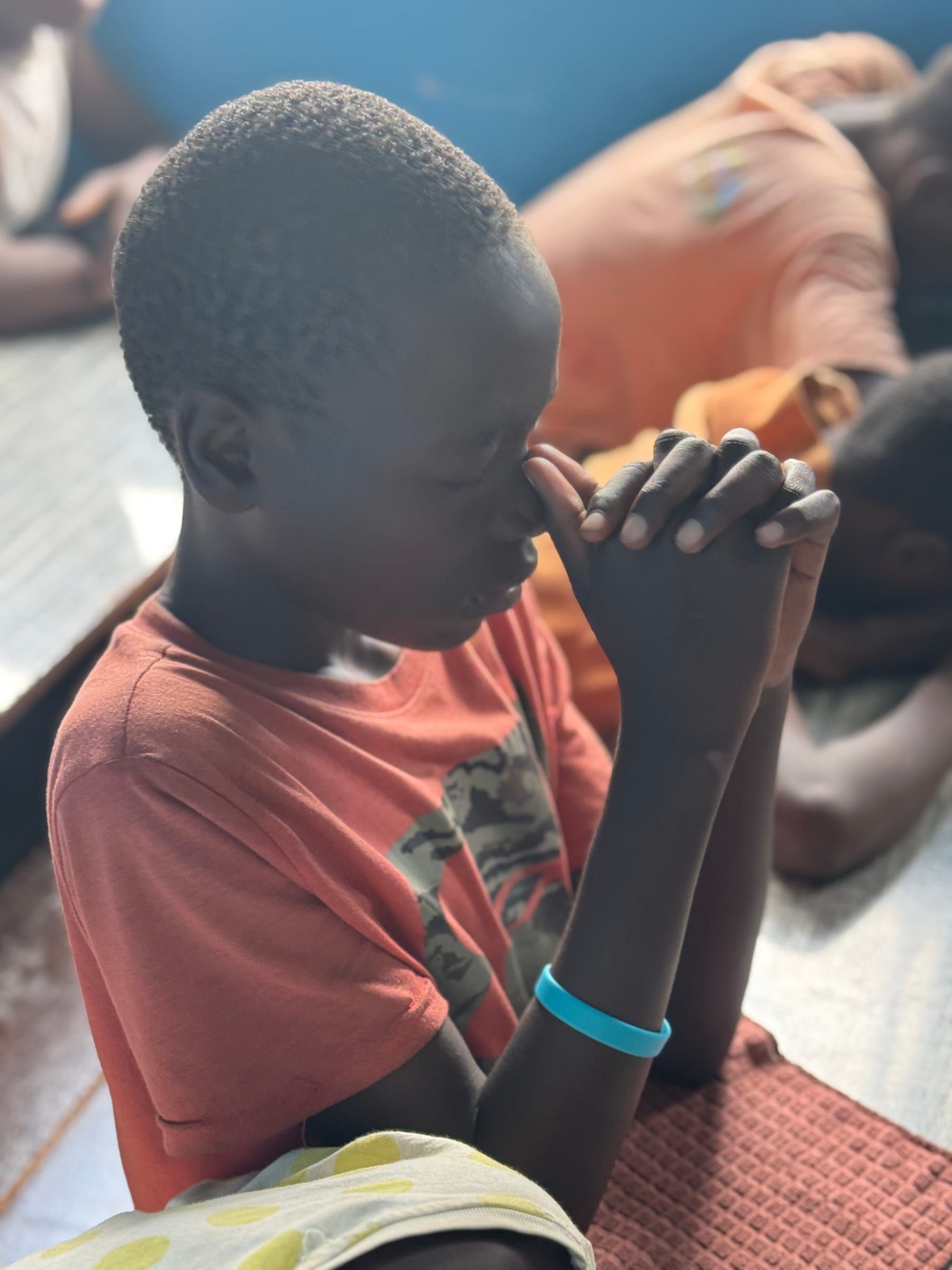 A boy praying during a discipleship moment at the Kitale Centre