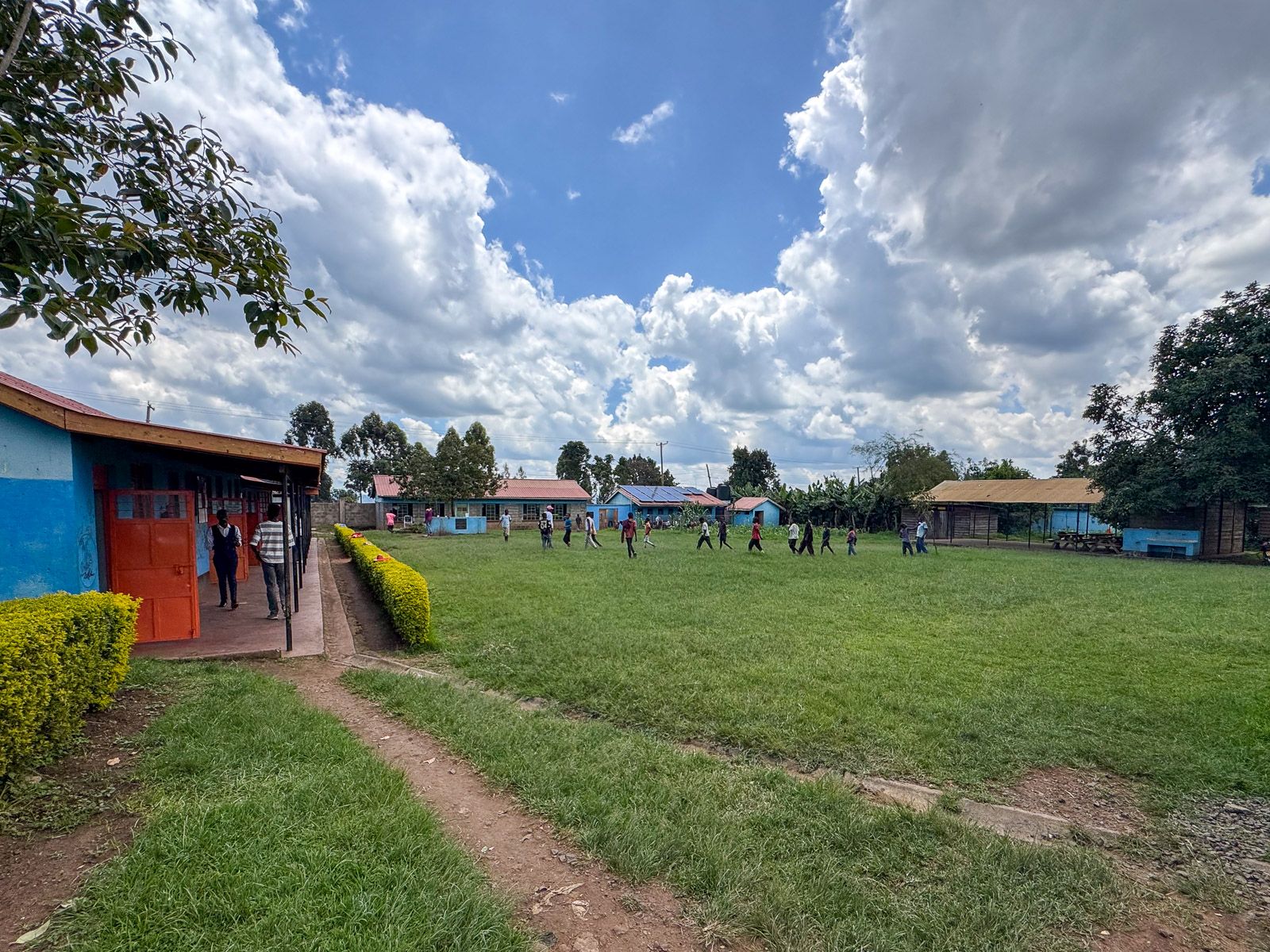 Kitale Centre campus with boys crossing the lawn