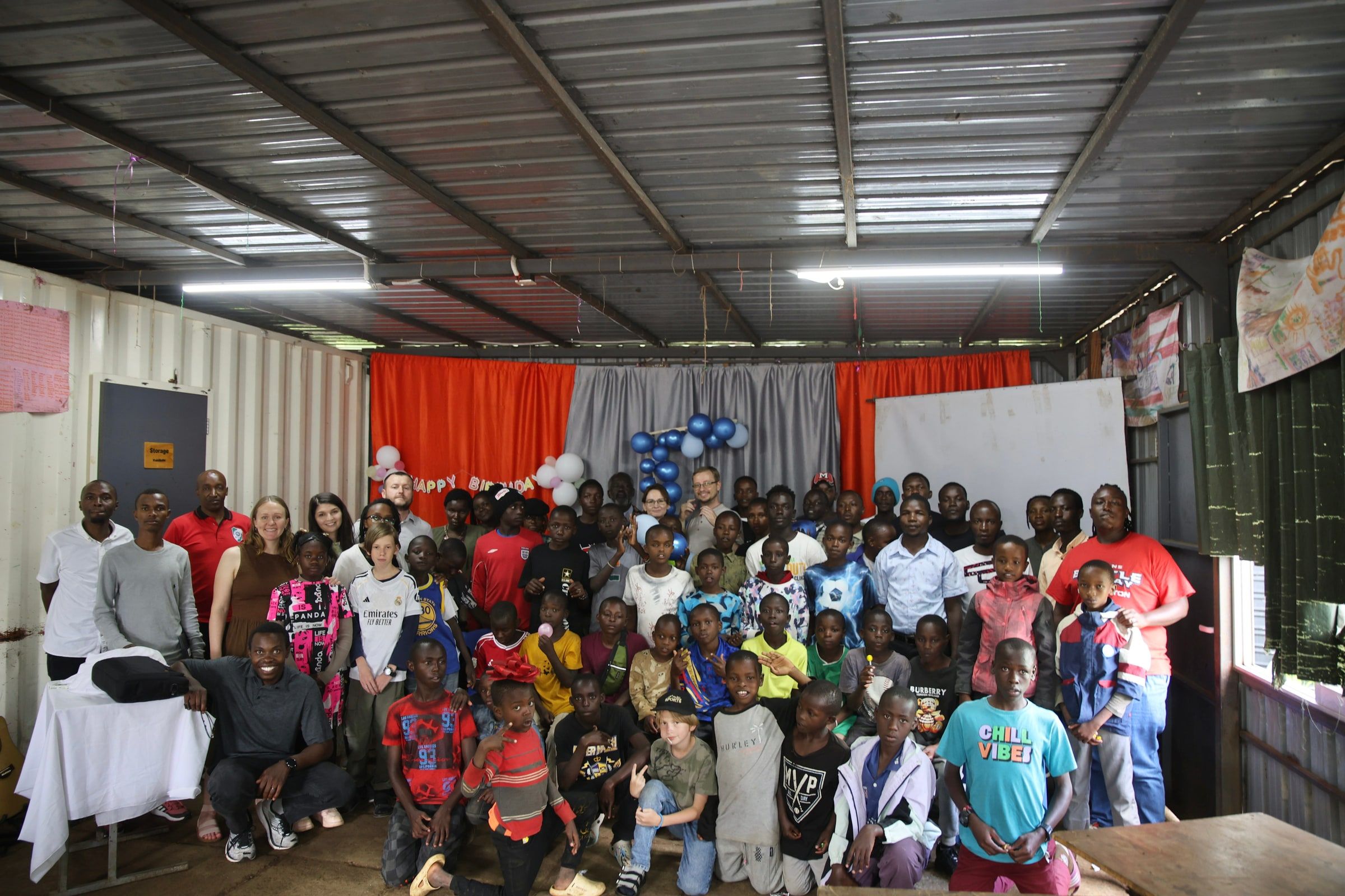 Embrace boys, staff, and visiting team members gathered together at the Centre