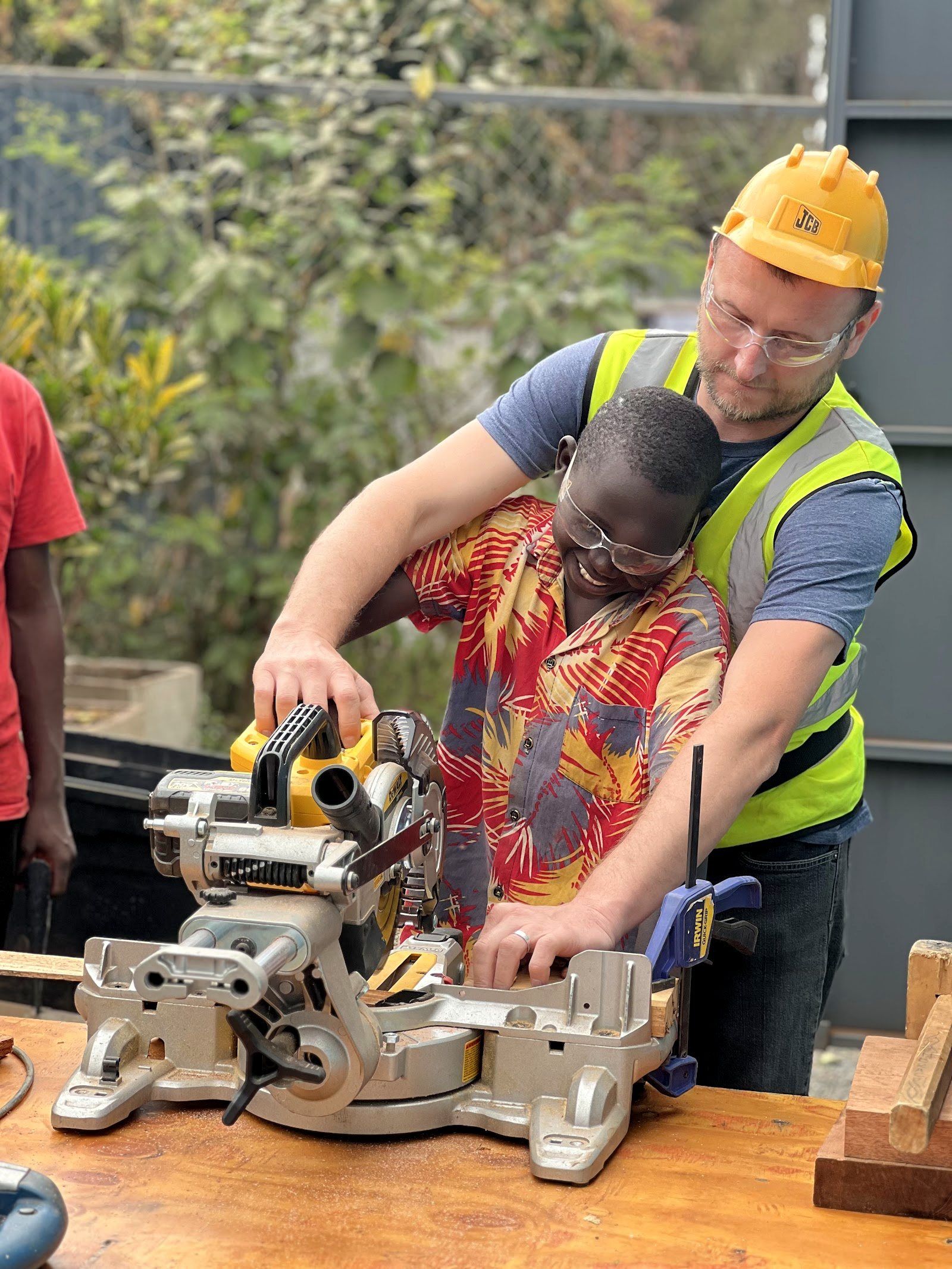A mentor guiding a boy through practical life-skills training at the Embrace Centre
