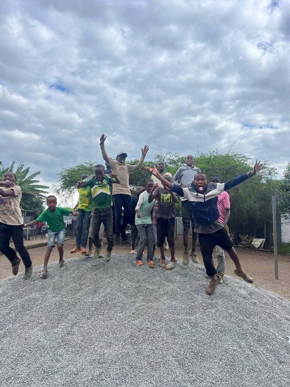 Boys celebrating together during a games and activities moment at the Embrace Centre
