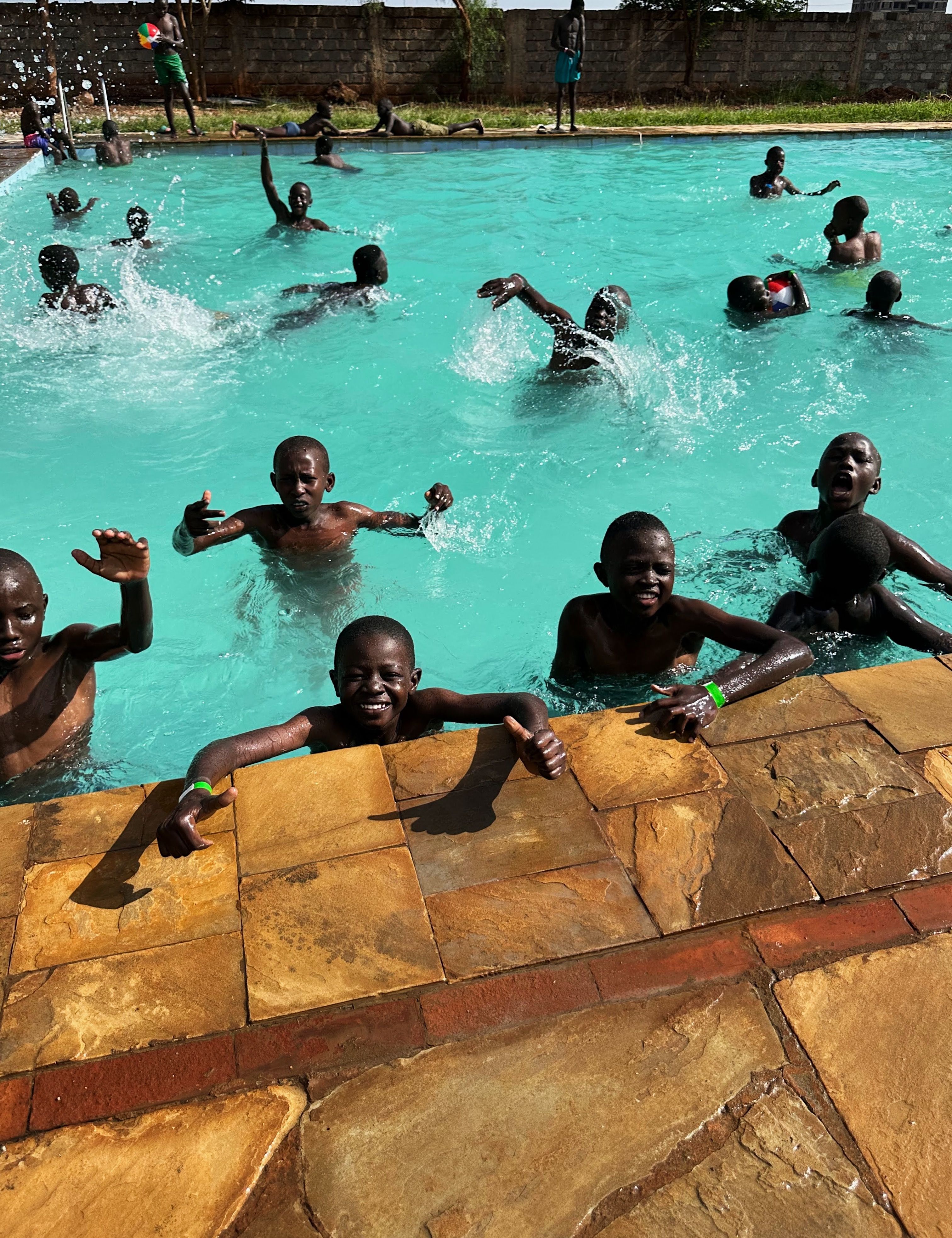 Boys swimming and playing together during Reconnect Camp