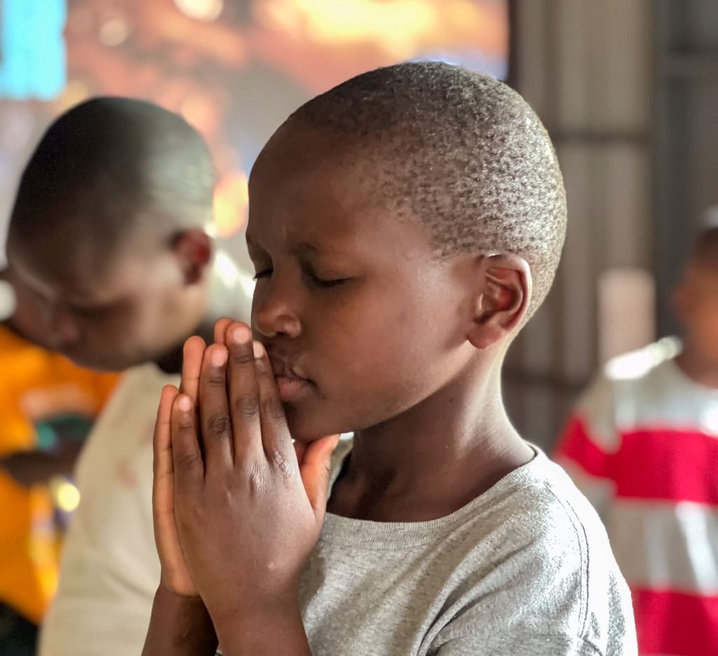 A boy being baptised during an Embrace programme