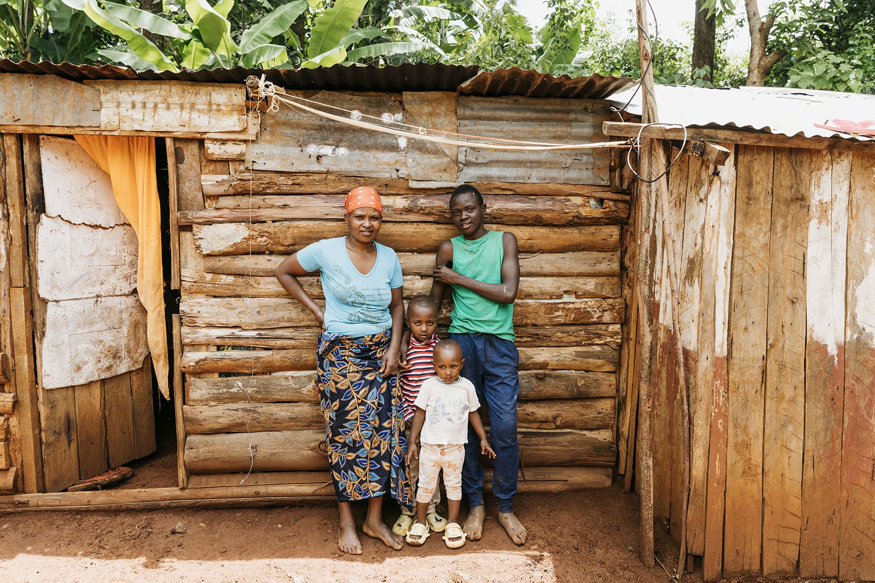 A family standing together outside their home during a reintegration visit