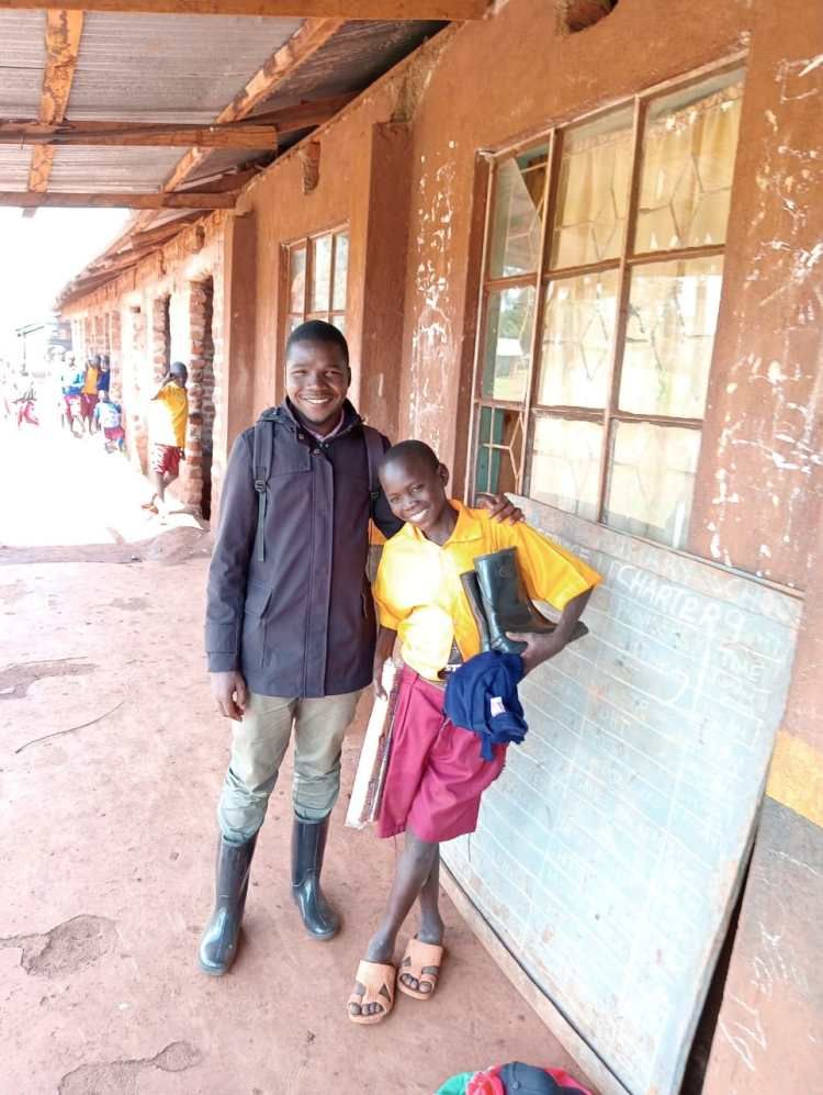An Embrace social worker visiting a boy at school during reintegration follow-up